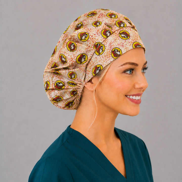 Beaver print bouffant scrub cap back view showing full print of red and yellow beaver mascot badges on speckled cream, OR World funny surgical hat