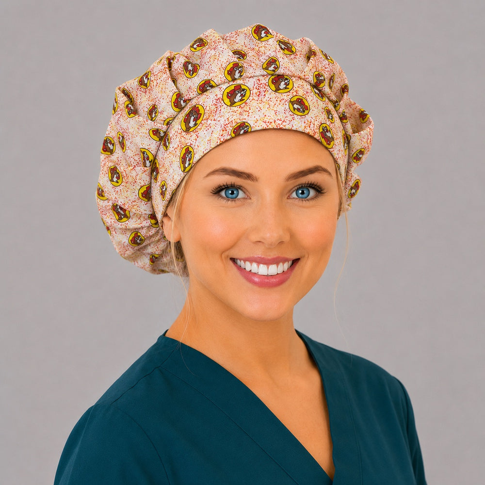 Beaver print bouffant scrub cap left side profile showing red and yellow beaver mascot badges on speckled cream, OR World funny surgical hat