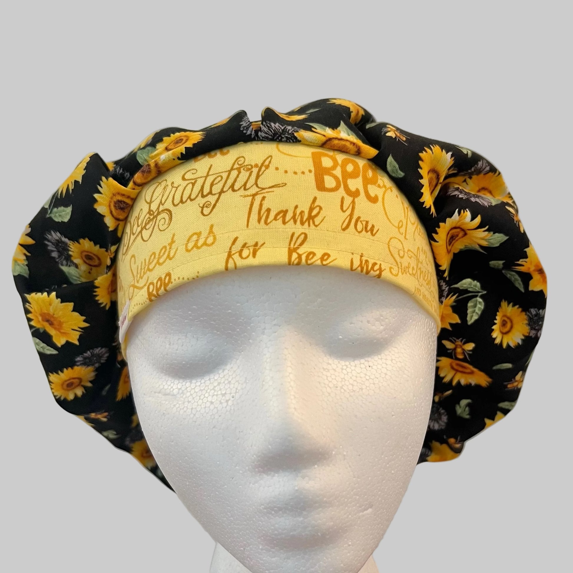 Profile view of Bee Grateful sunflower bouffant scrub cap — handmade-in-USA surgical hat, cheerful gift for nurses & sunflower lovers.