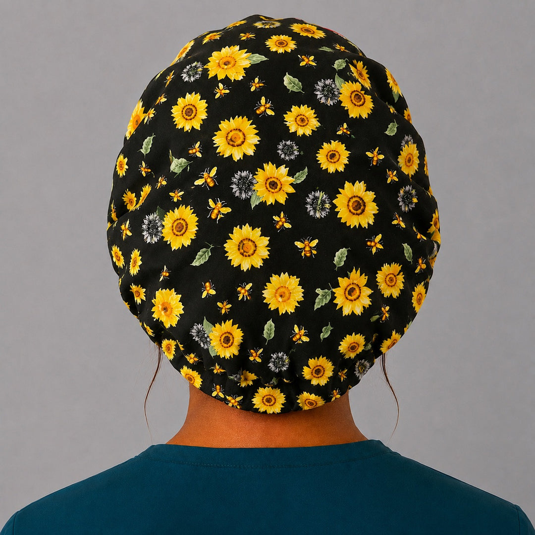 Bee Grateful sunflower bouffant scrub cap back view showing full print of golden sunflowers and honeybees on black, OR World surgical hat