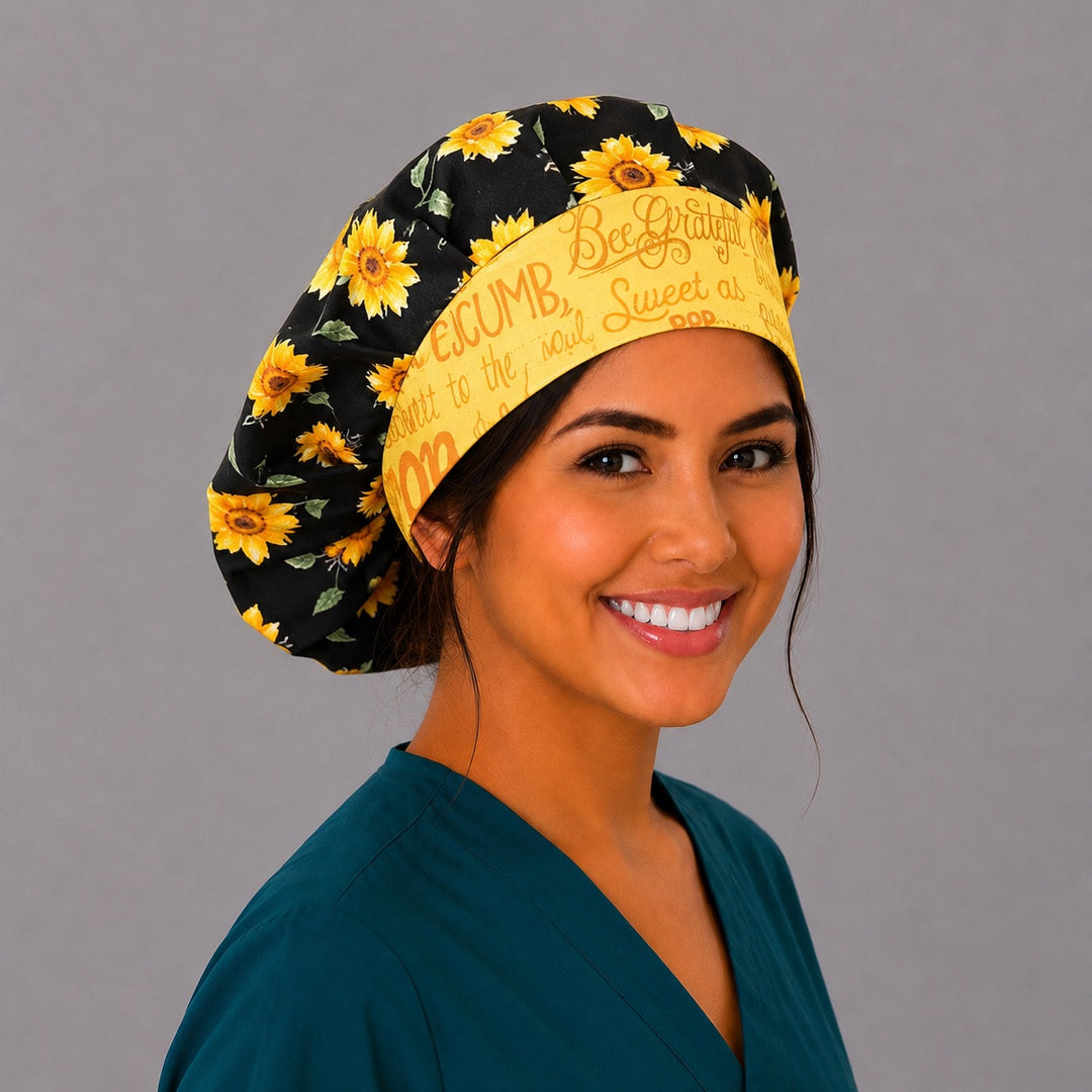 Bee Grateful sunflower bouffant scrub cap right three-quarter angle on smiling model showing sunflowers, honeybees on black and yellow script band, OR World surgical hat