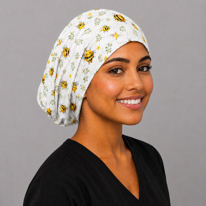 Bee Happy Blooms honeybee floral Euro scrub cap, three quarter view on a model — handmade USA surgical hat, cheerful gift for nurses and bee lovers.