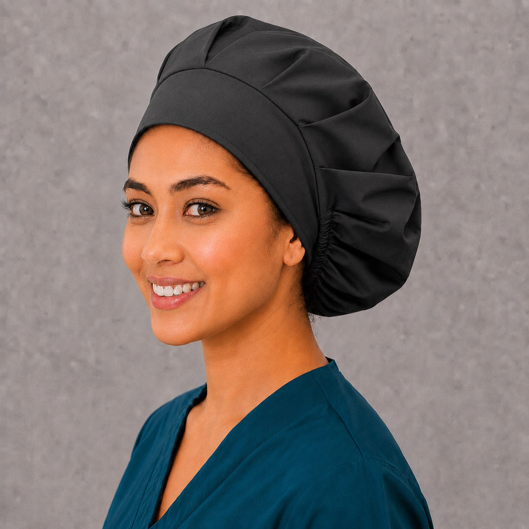 Black bouffant cap for women, left angled smiling view — handmade plain black surgical cap, USA made