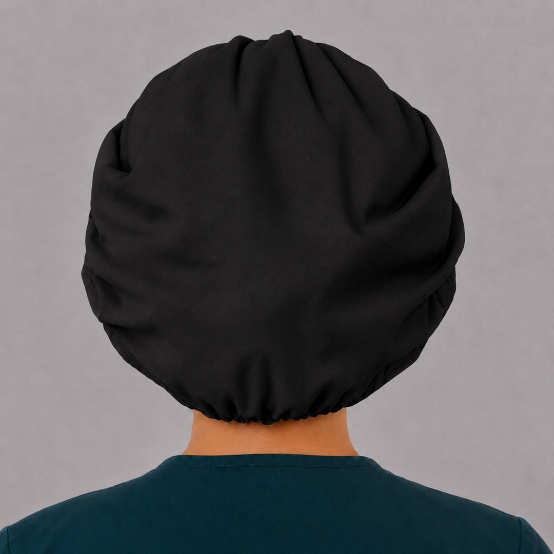 Back view of the black bouffant scrub cap — full roomy fit with elastic gather that holds thick hair securely