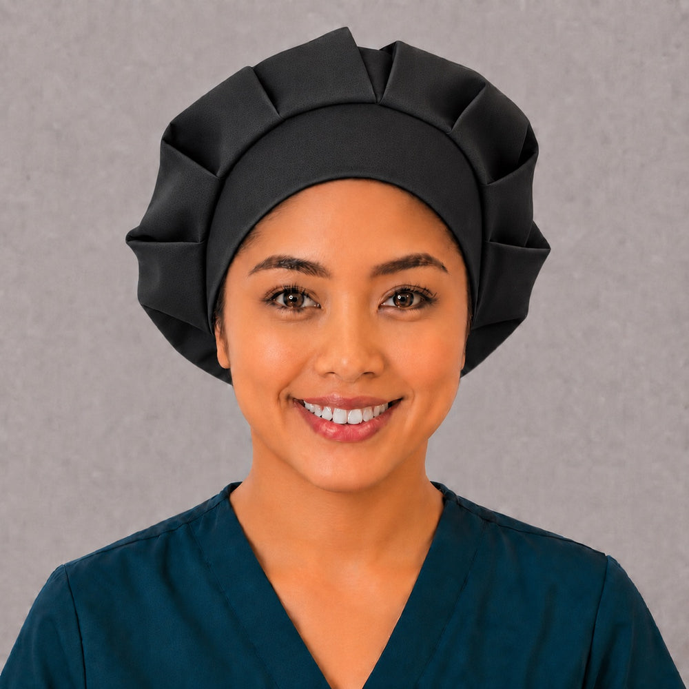 Woman wearing a solid black bouffant scrub cap, front view — classic plain black adjustable surgical hat for nurses