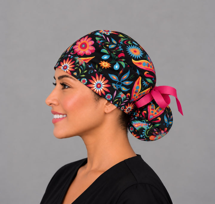 Black Mexican floral ponytail scrub cap, right side profile — turquoise and gold starflower print for OR nurses and surgical techs