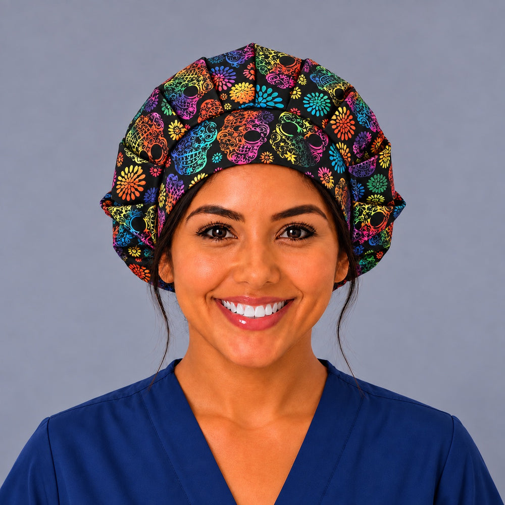 Nurse wearing a black rainbow calavera bouffant surgical hat, front view, pleated full crown with lacy rainbow skulls