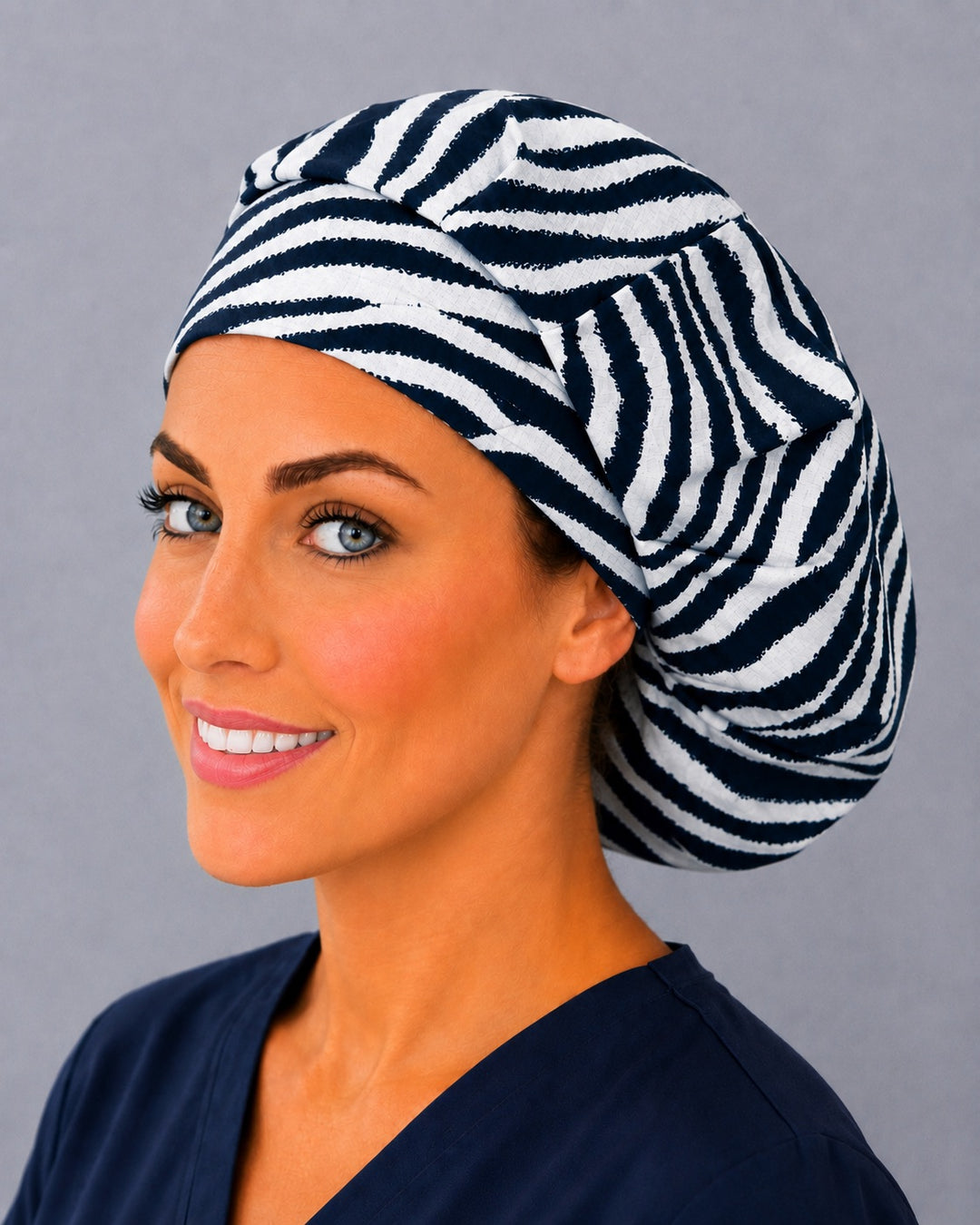 Black and white zebra bouffant surgical cap, left angled view — bold stripe print for OR nurses, surgical techs and vet teams