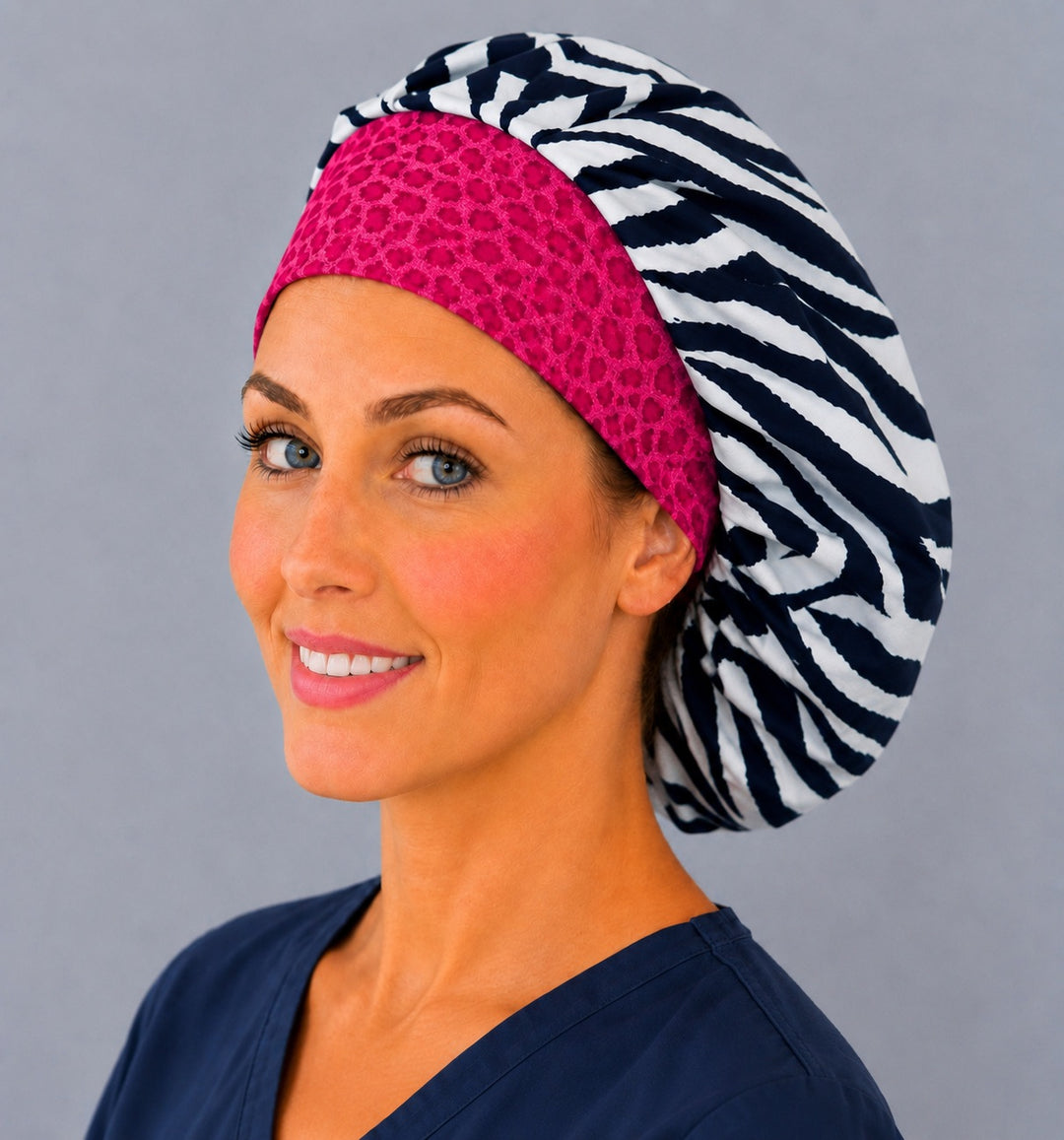 Black and white zebra bouffant surgical cap for long hair, left angled view — deep gathered fit that secures thick or braided hair