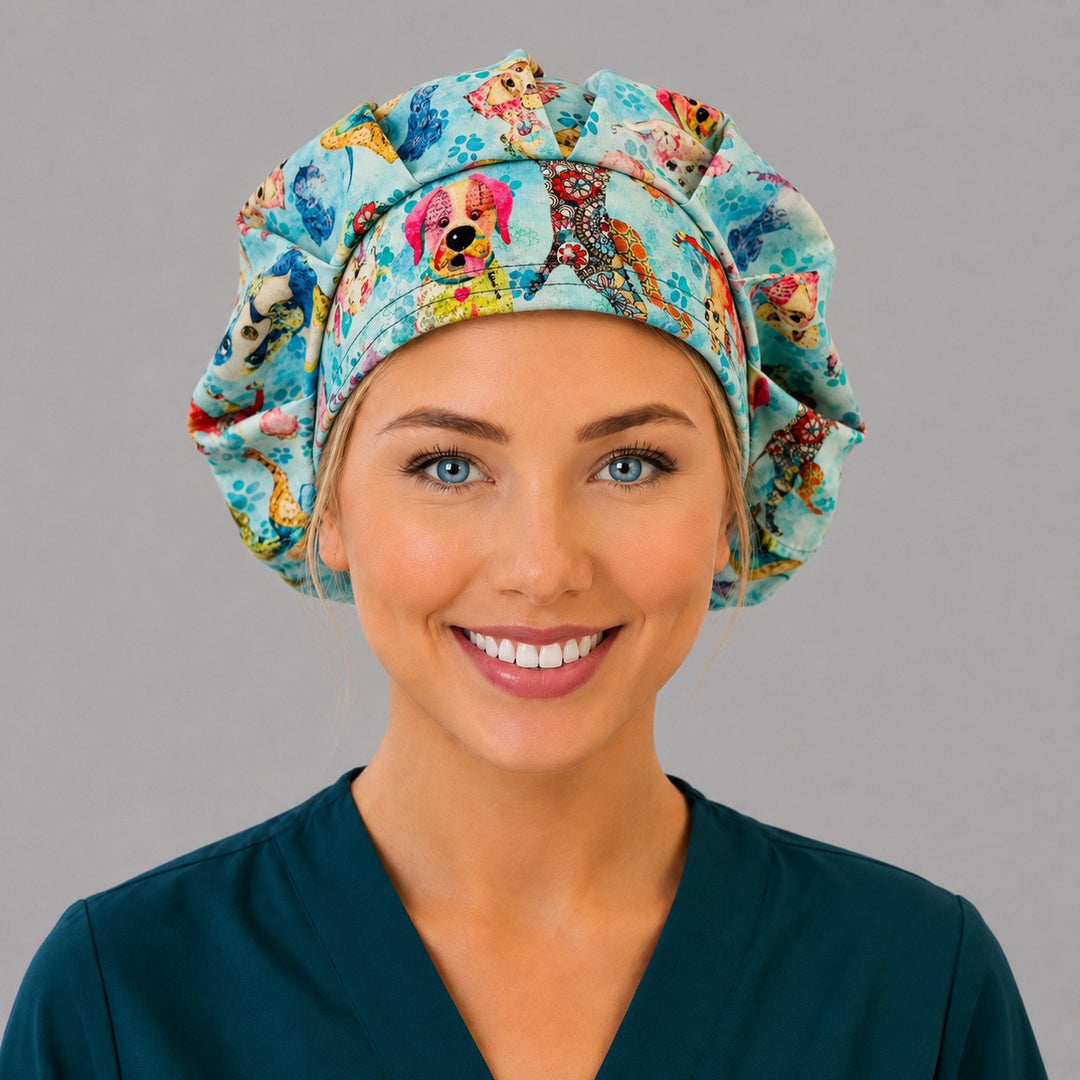 Woman wearing a blue puppy dog bouffant scrub cap, front view — colorful watercolor dogs and paw prints, adjustable women&