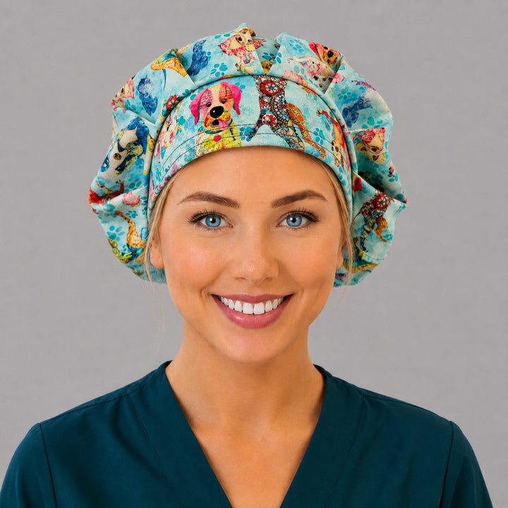 Woman wearing a blue puppy dog bouffant scrub cap, front view — colorful watercolor dogs and paw prints, adjustable women&