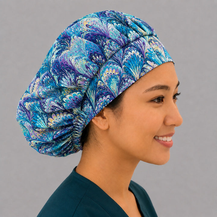 Blue and purple ripples bouffant scrub cap left side profile showing marbled turquoise blue and purple swirl print, OR World surgical hat