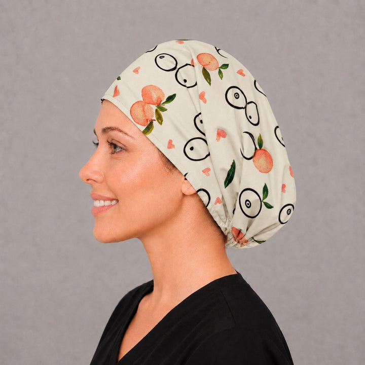 Left side profile of the breast surgery Euro surgical hat — watercolor peach and line-art print, breathable cotton cap for OR teams