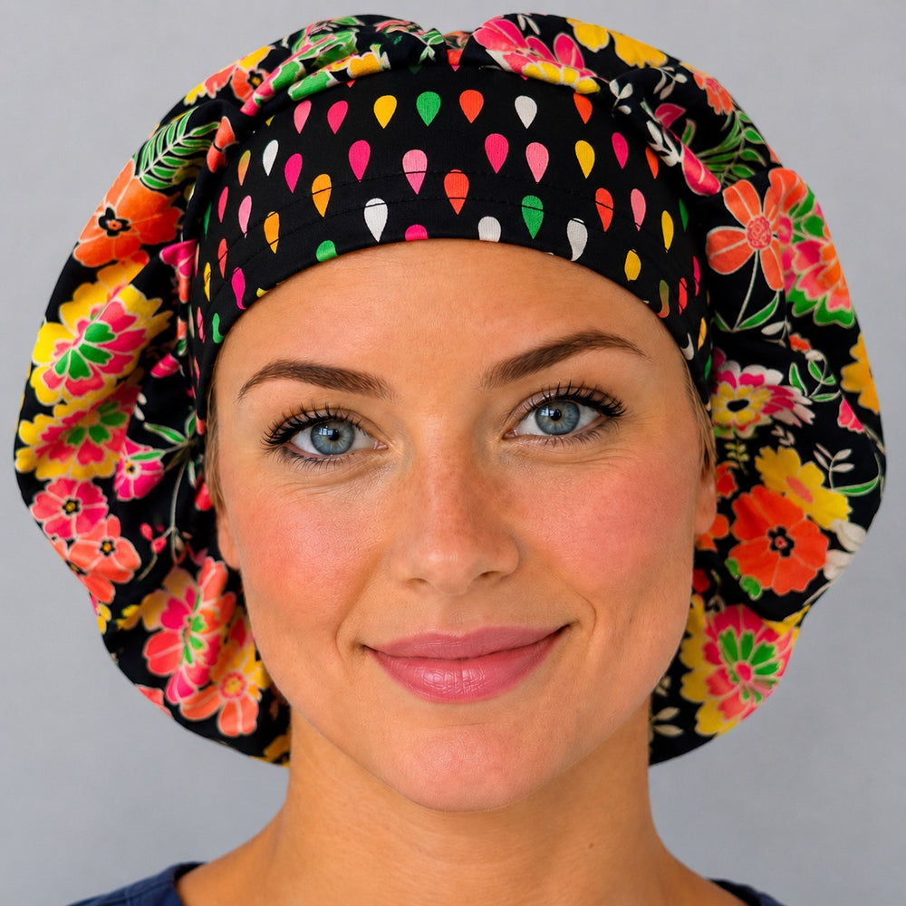 Bright floral neon flower bouffant scrub cap for women, front view, bold pink coral and yellow flowers on navy with confetti-dot band, handmade surgical hat by OR World