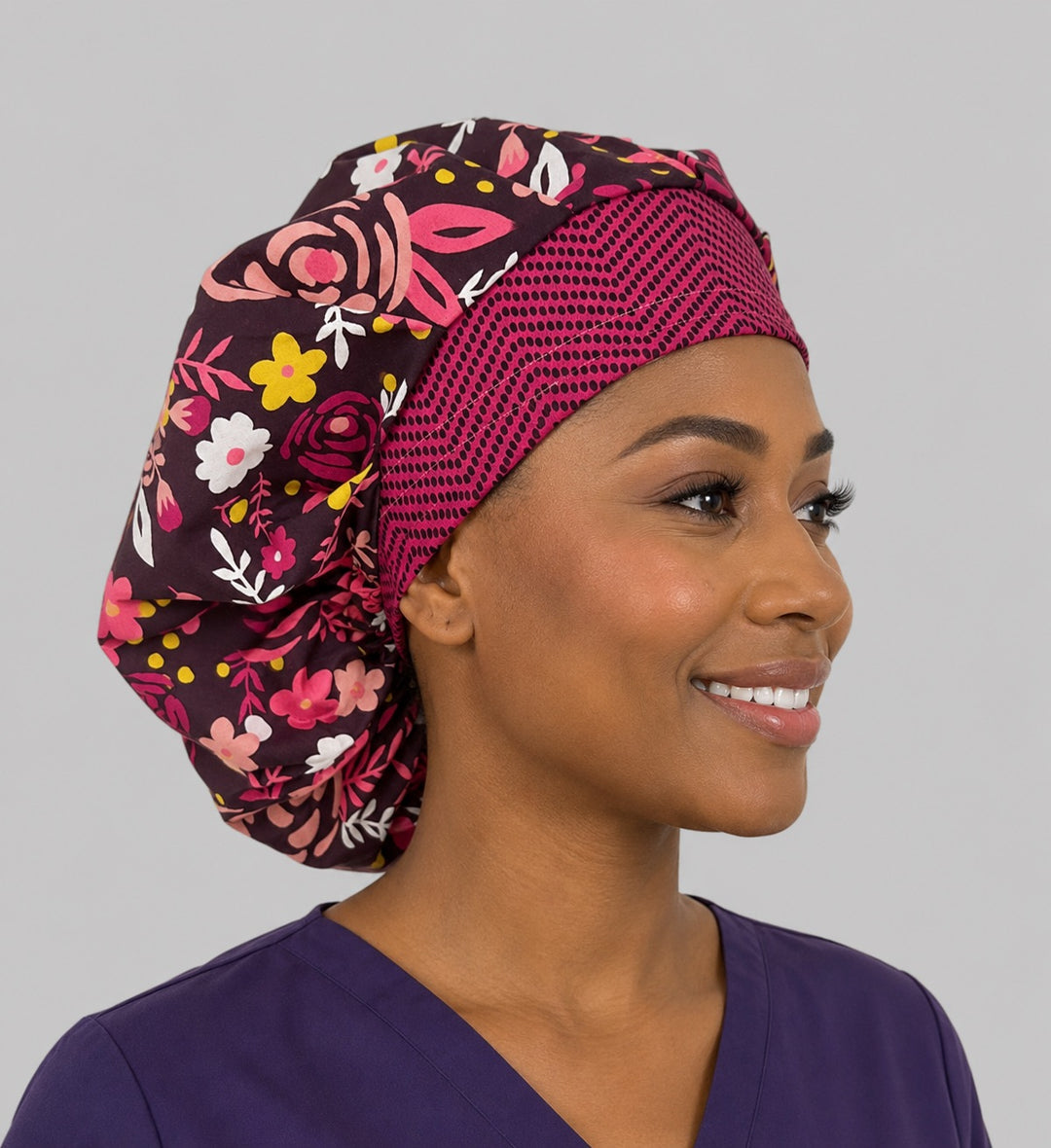 Side view of the brown floral bouffant surgical hat — rose and daisy print with hot pink geometric band, roomy cotton cap for OR nurses
