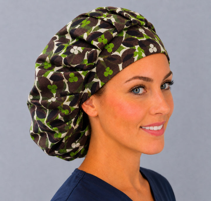 Brown and green vine bouffant scrub cap, right angled smiling view — 70s botanical print for OR nurses and surgical techs