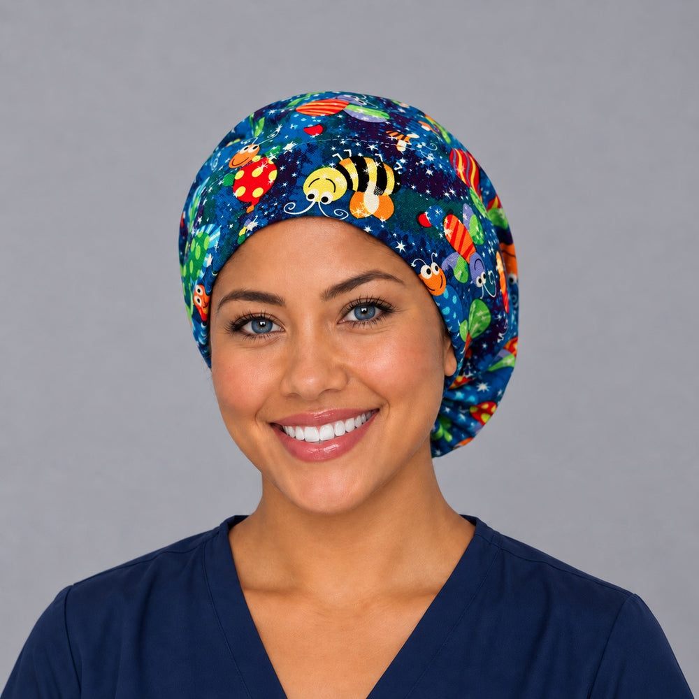 Woman wearing a colorful bugs and butterflies Euro scrub cap, front view — bees and ladybugs on cobalt blue, adjustable surgical hat