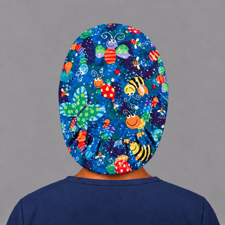 Back view of the bugs and butterflies Euro scrub cap — elastic gathered back showing bees and butterflies across the blue crown