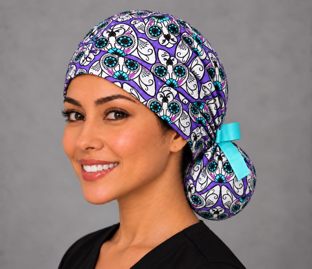 Calavera cat ponytail scrub cap, left angled smiling view — spiderweb cheek detail for OR nurses and vet techs
