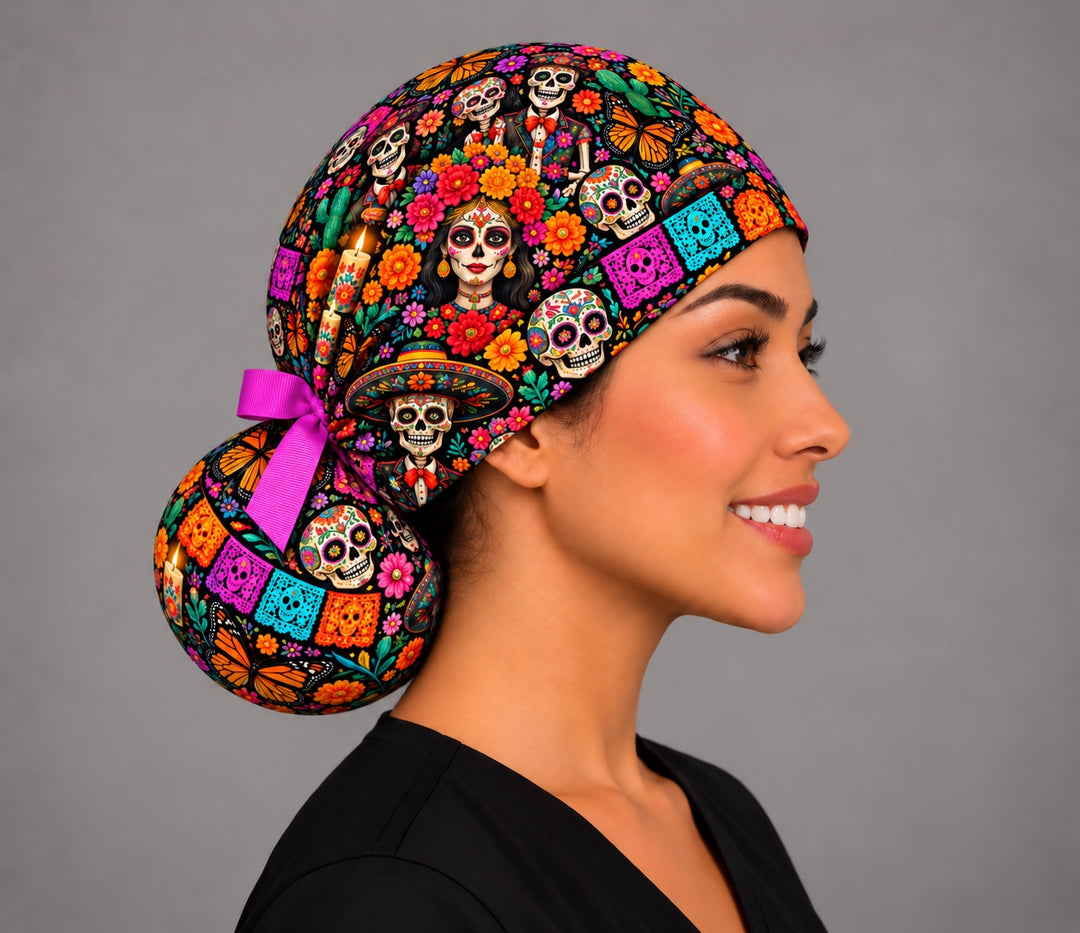 Right profile of a calavera ponytail scrub cap for long hair with a flower-crowned catrina, veladoras and monarch butterflies