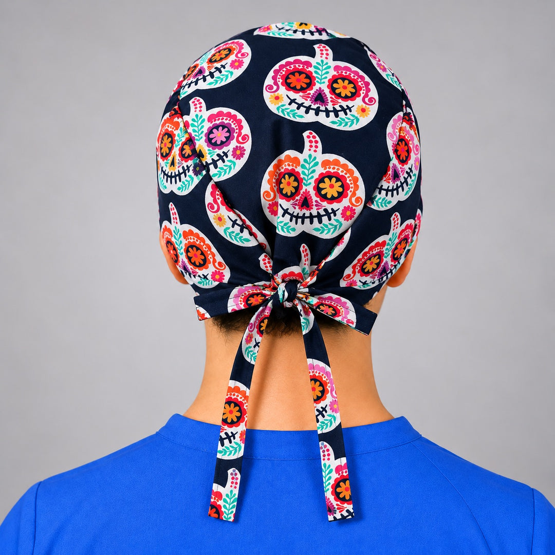 Rear knot and ties on calavera pumpkin scrub hat, unisex Mexican folk art OR cap shown from behind