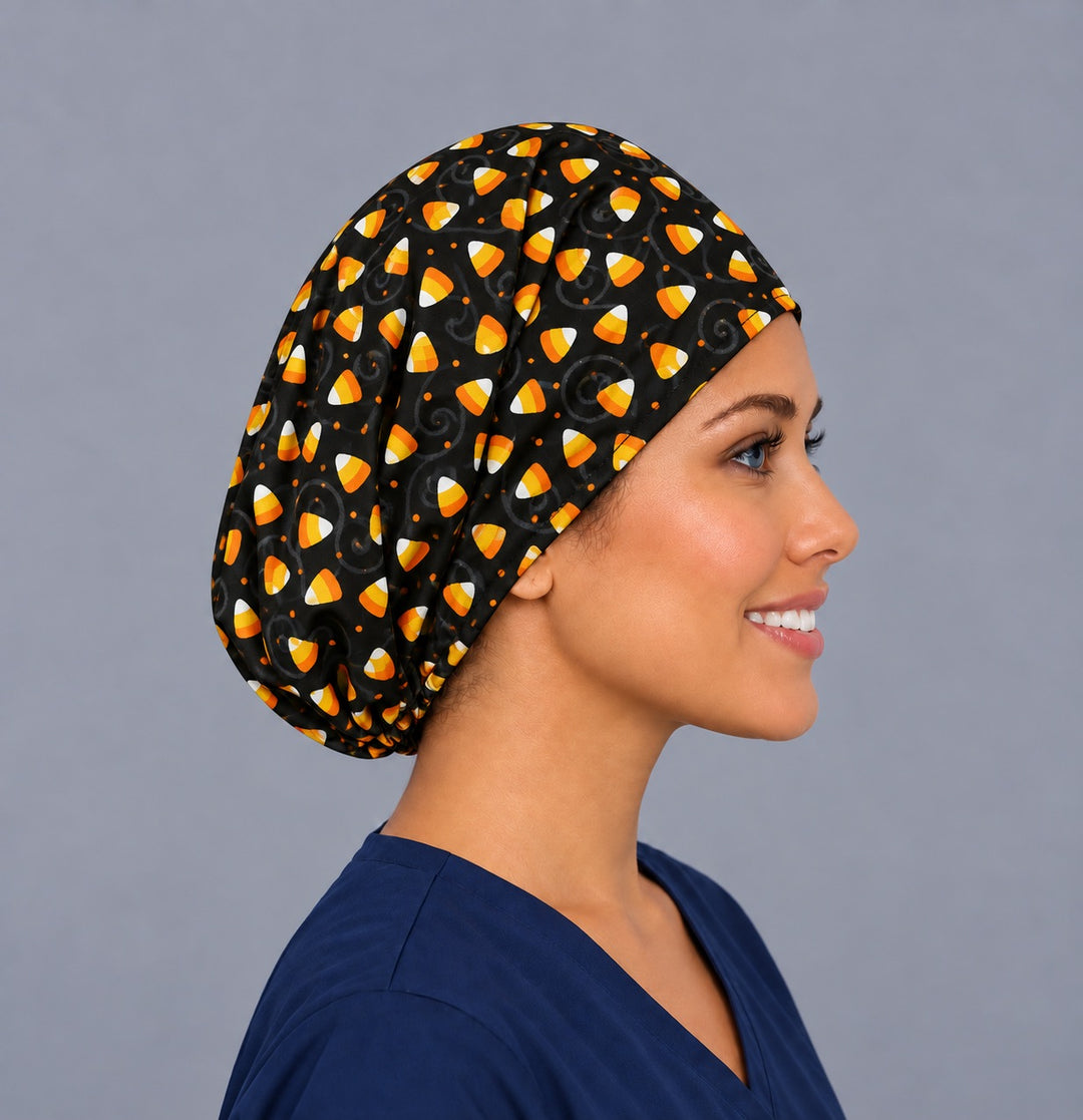Right side profile of the candy corn Euro surgical hat — black swirl and dot print, breathable cotton cap for nurses