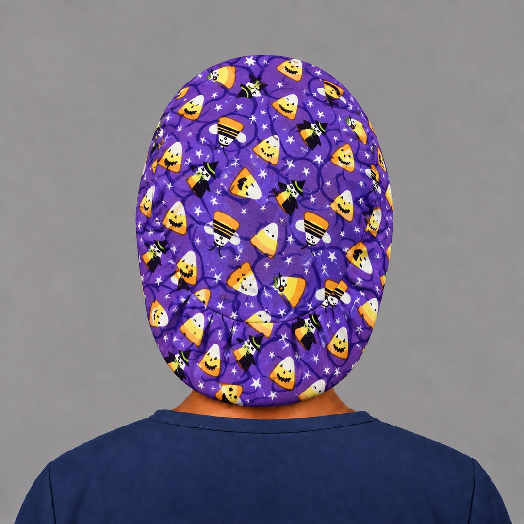 Back view of the candy corn witches Euro scrub cap — elastic gathered back showing candy corn and stars across the purple crown