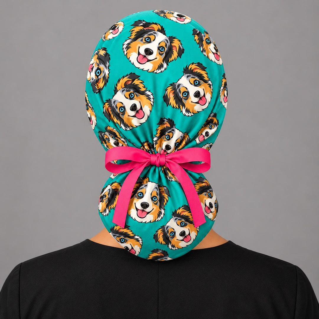 Back view of a cartoon pet ponytail scrub cap showing the ponytail pouch and adjustable pink ribbon tie for long hair