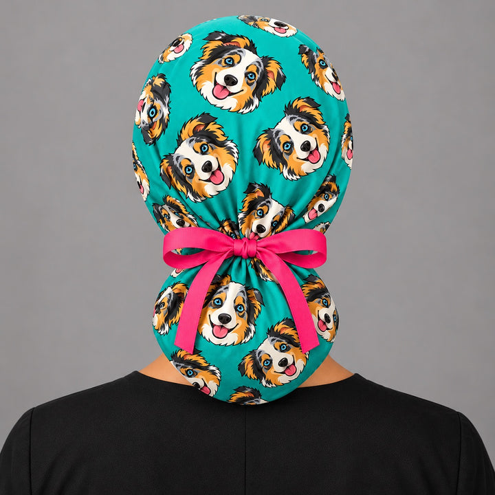 Back view of a cartoon pet ponytail scrub cap showing the ponytail pouch and adjustable pink ribbon tie for long hair