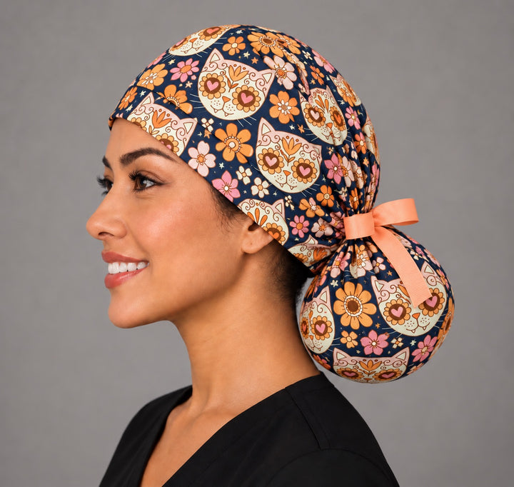 Left profile of the cat lover ponytail scrub cap on a vet tech, round bun pouch and peach bow, handmade in the USA