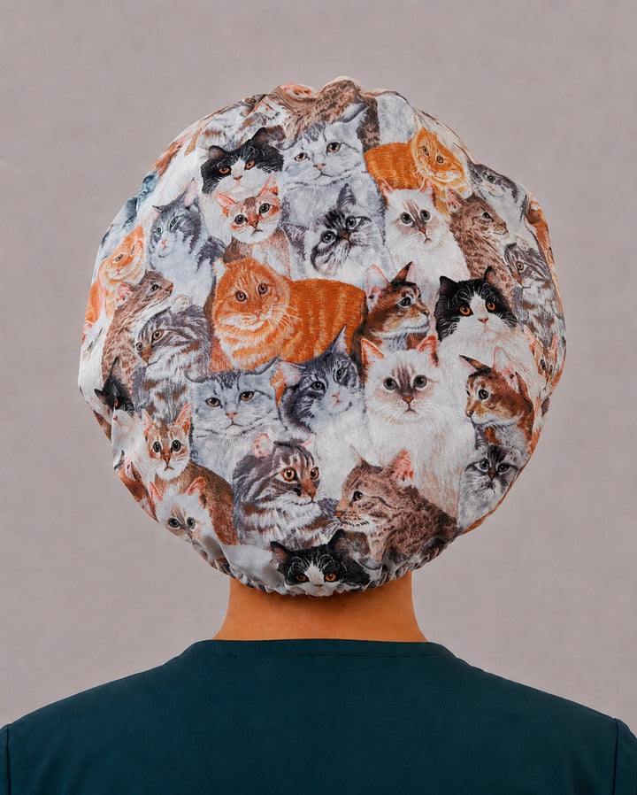 Back view of the cats and kittens bouffant scrub cap — full gathered coverage showing dozens of cat faces across the crown