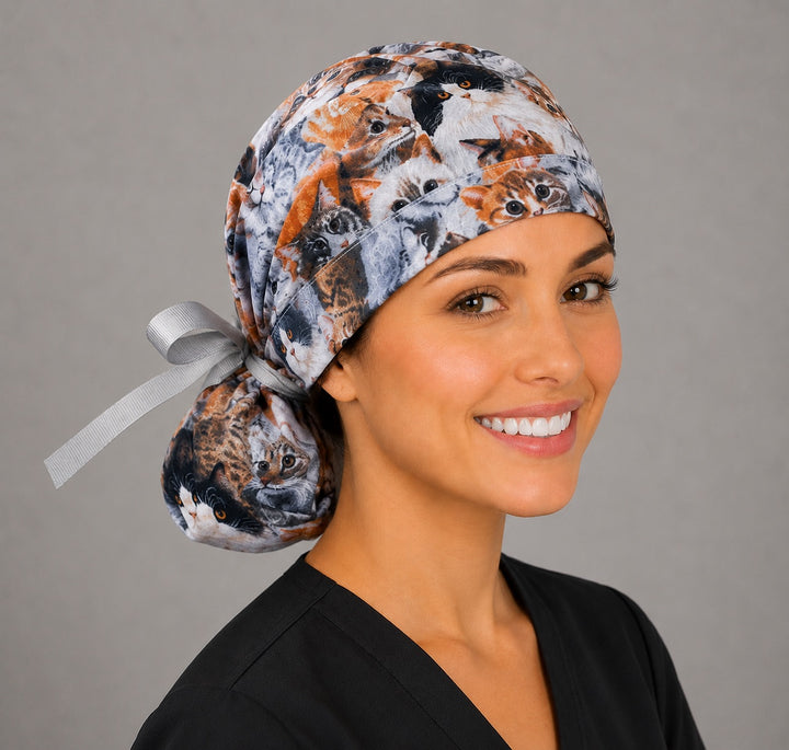 Cats and kittens ponytail surgical cap left side profile with gathered pouch of tabby, ginger and calico cats and gray grosgrain ribbon tie