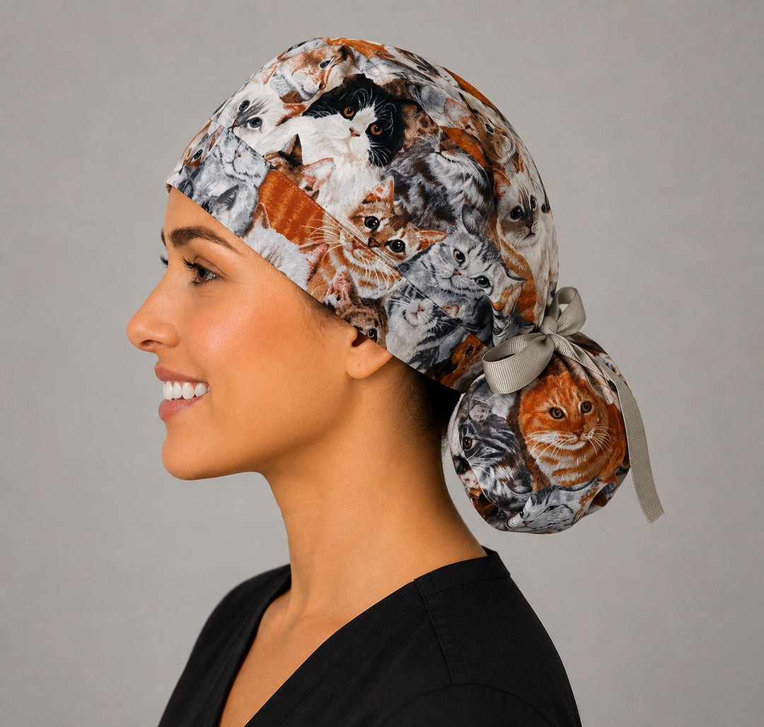 Cats and kittens ponytail nurse cap left three-quarter angle showing gathered ponytail pouch of realistic cats and kittens with gray ribbon bow