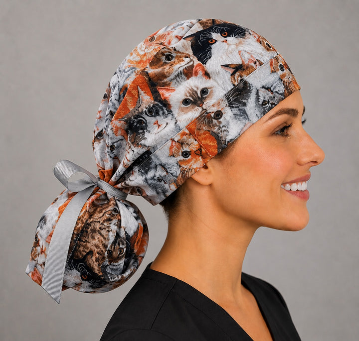 Cats and kittens ponytail scrub cap ponytail pouch close-up showing detailed tabby, tuxedo and ginger cats with gray ribbon bow