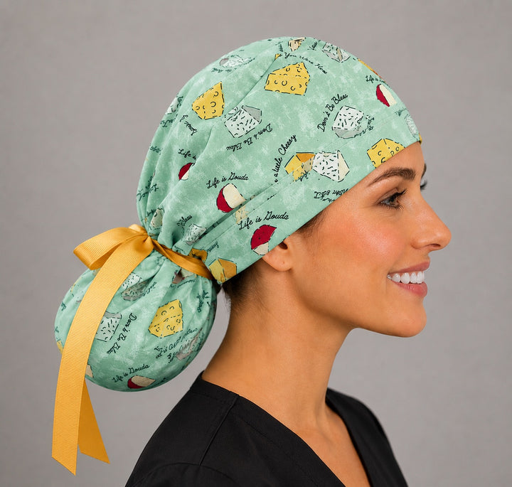 Funny cheese pun ponytail scrub cap right side profile showing gathered pouch of cheese illustrations and long yellow ribbon ties
