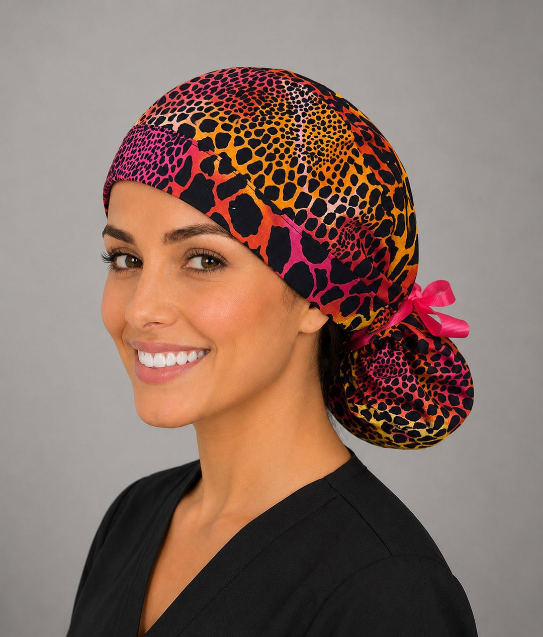 Neon cheetah leopard ponytail scrub cap right side profile with full ponytail pouch of pink orange yellow animal print and long hot pink ribbon ties