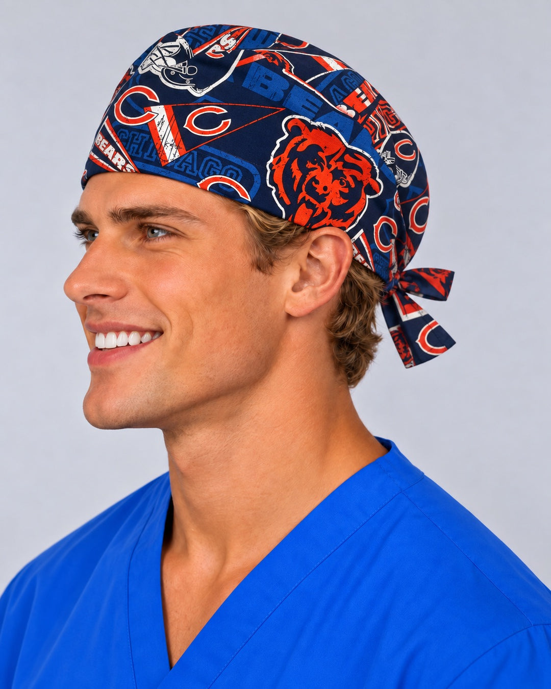 Smiling male surgeon in royal blue scrubs wearing the Chicago Football 