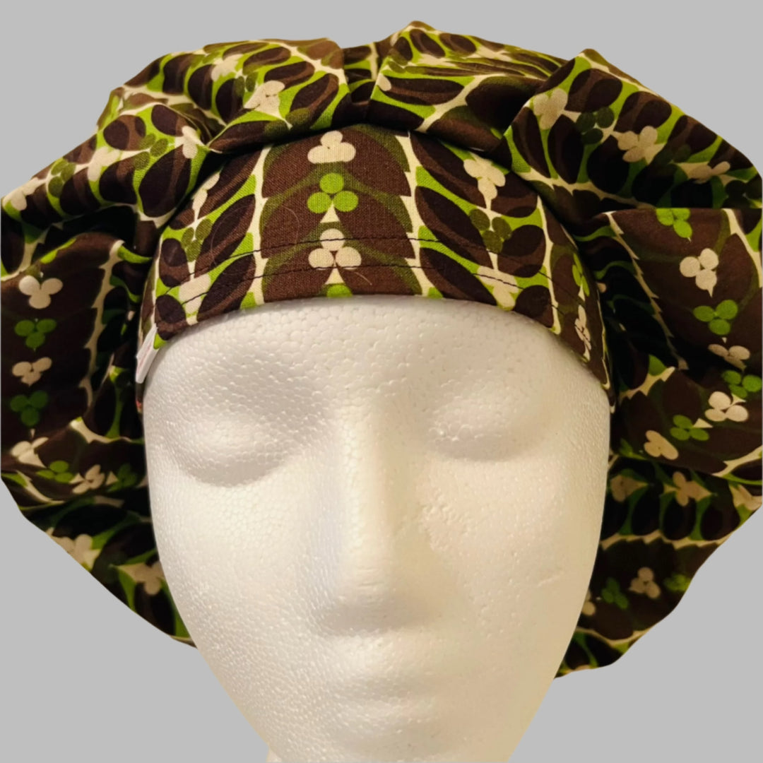 Chocolate mint bouffant scrub cap in a retro brown & green leaf pattern on a model — handmade-in-USA surgical hat for women from OR World.