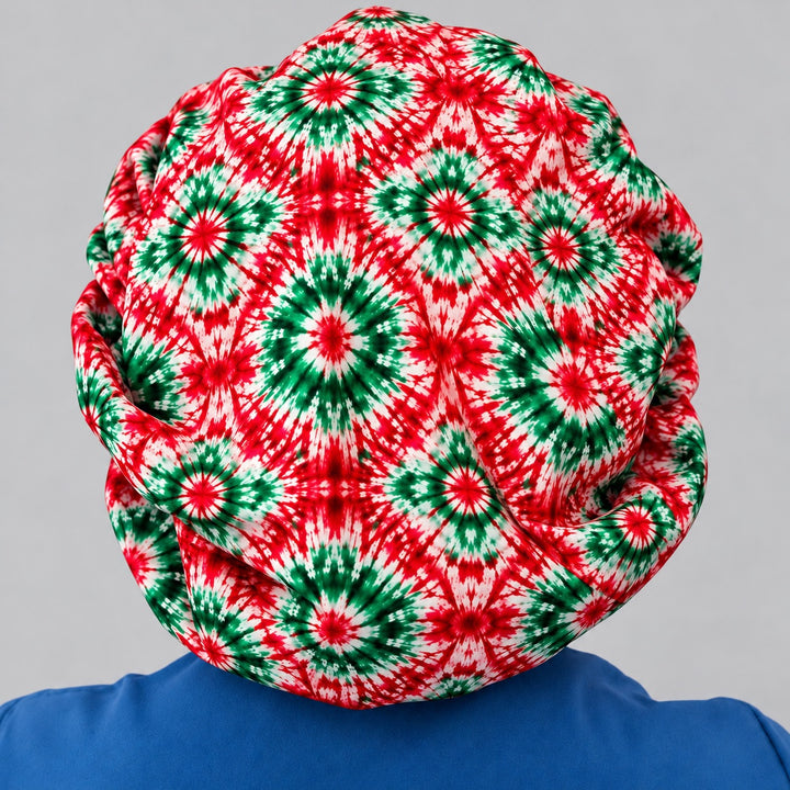Back of the Christmas bouffant scrub cap showing full hair coverage in red and green starburst print