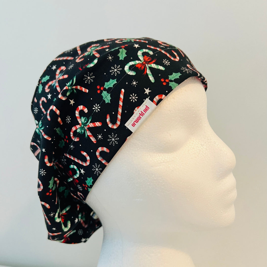 Christmas Candy Cane Euro scrub cap with festive candy canes, holly leaves, bows, stars, and snowflakes on a black background, comfortable surgical cap for nurses, surgeons, doctors, and healthcare professionals, right side view.