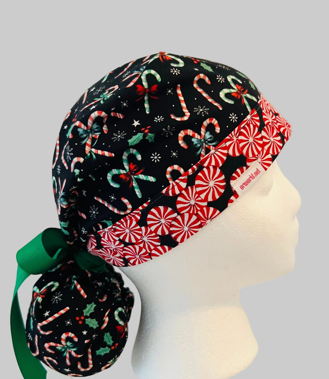 Christmas candy cane peppermint ponytail scrub cap with festive red and green candy canes, peppermint band, holly, bows, and snowflakes for nurses, surgeons, healthcare professionals, surgical staff, and holiday medical uniforms, right side view.