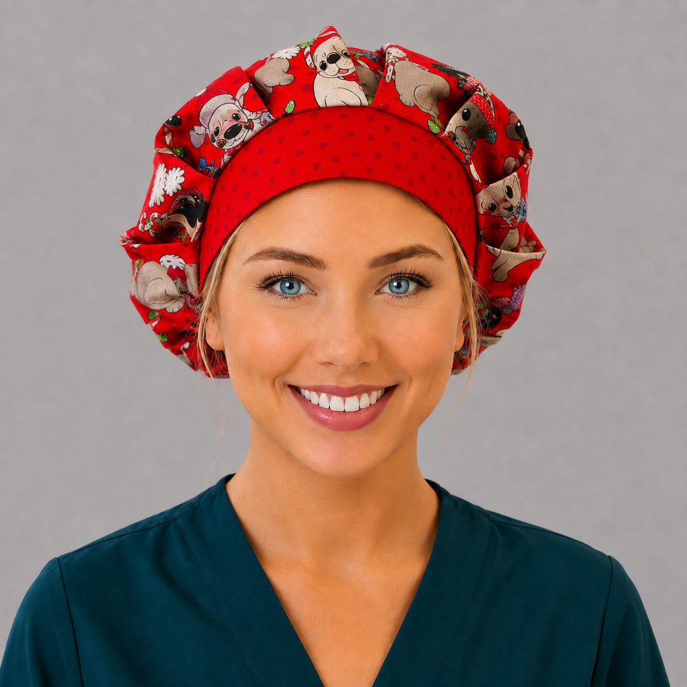 Woman wearing a Christmas dog bouffant scrub cap, front view — puppies in Santa hats on red with a tonal polka-dot band, adjustable women's surgical hat