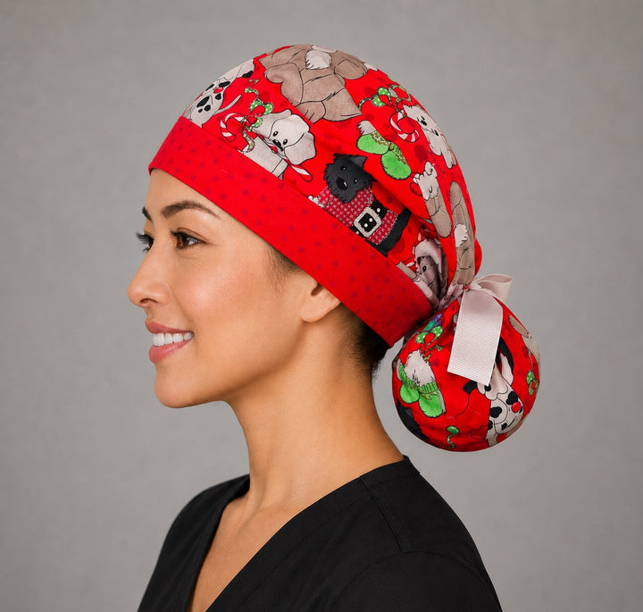 Christmas dogs ponytail scrub cap left side profile with full ponytail pouch of pups in Santa hats and sweaters on red and long white ribbon ties