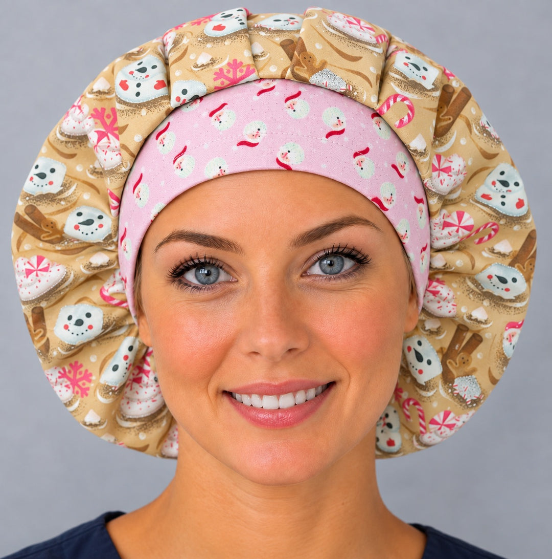 Woman wearing a Christmas marshmallow bouffant scrub cap, front view — pink Santa snowman band with gold cocoa print, full coverage surgical hat