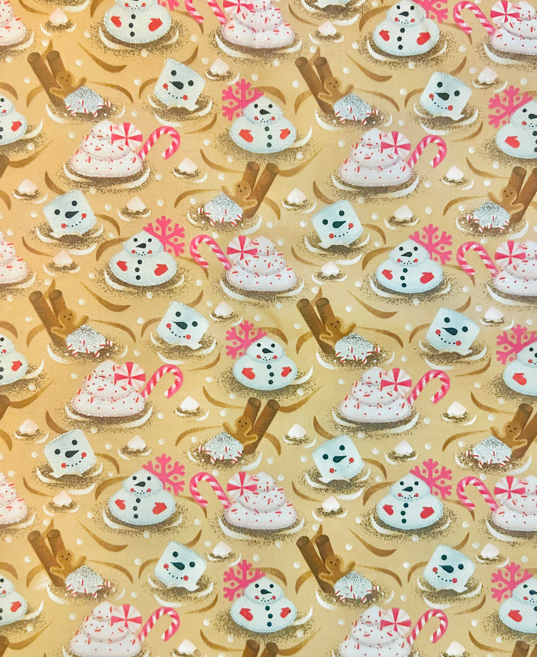 Fabric detail of the Christmas marshmallow scrub cap — close-up of snowman marshmallows, candy canes and gingerbread spoons on gold cotton