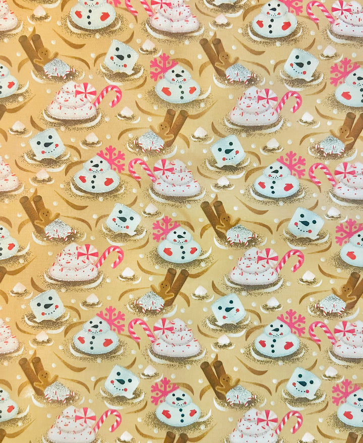 Fabric detail of the Christmas marshmallow scrub cap — close-up of snowman marshmallows, candy canes and gingerbread spoons on gold cotton