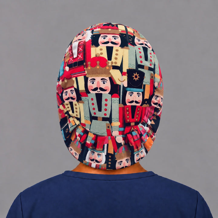 Back view of the Christmas nutcracker Euro scrub cap — elastic gathered back showing nutcracker soldiers across the navy crown