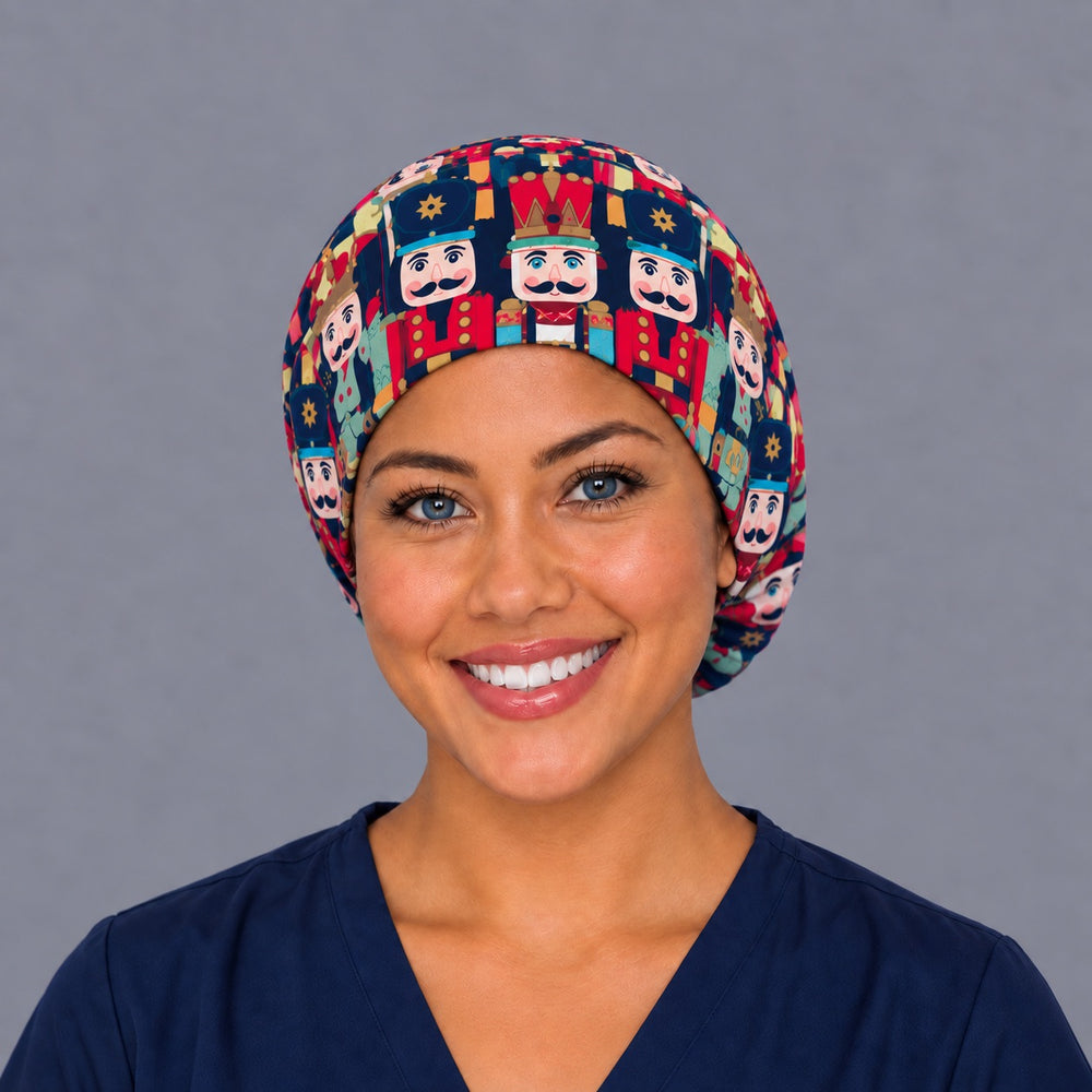 Woman wearing a Christmas nutcracker Euro scrub cap, front view — red and teal nutcracker soldiers on navy, adjustable holiday surgical hat