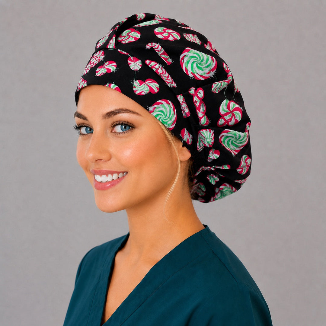 Christmas peppermint bouffant surgical cap, left angled smiling view — festive black candy print bouffant hat for nurses and surgical techs