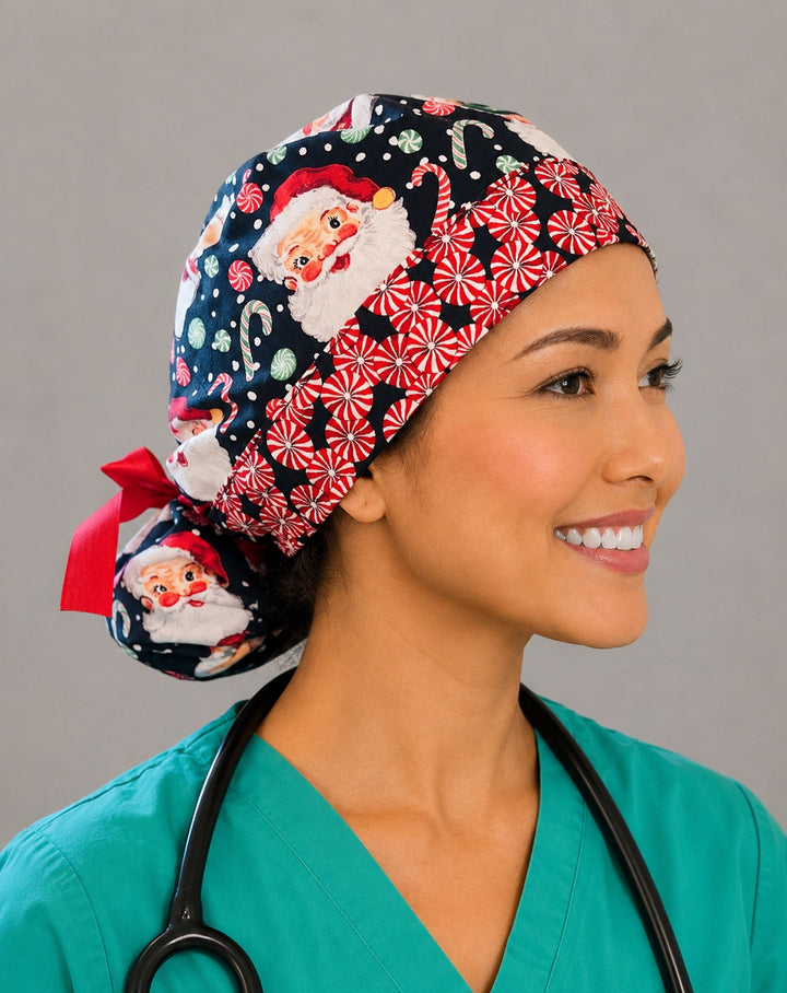 Christmas Santa ponytail nurse cap right three-quarter angle on smiling model showing vintage Santa faces, peppermints and candy canes on navy with peppermint band and red ribbon bow